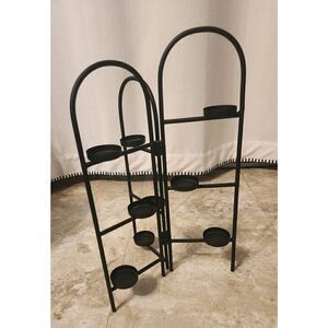 Decorative standing black metal with small glass votive candle holders